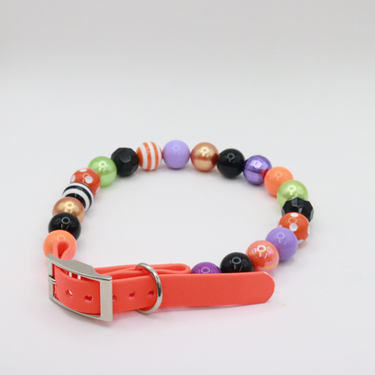 AnitasStitches adjustable Halloween dog collar featuring vibrant multi-colored beads and a durable orange strap