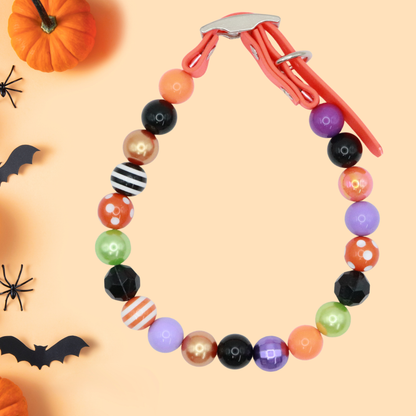 AnitasStitches adjustable Halloween dog collar with colorful beads and a waterproof Biothane strap on a festive background