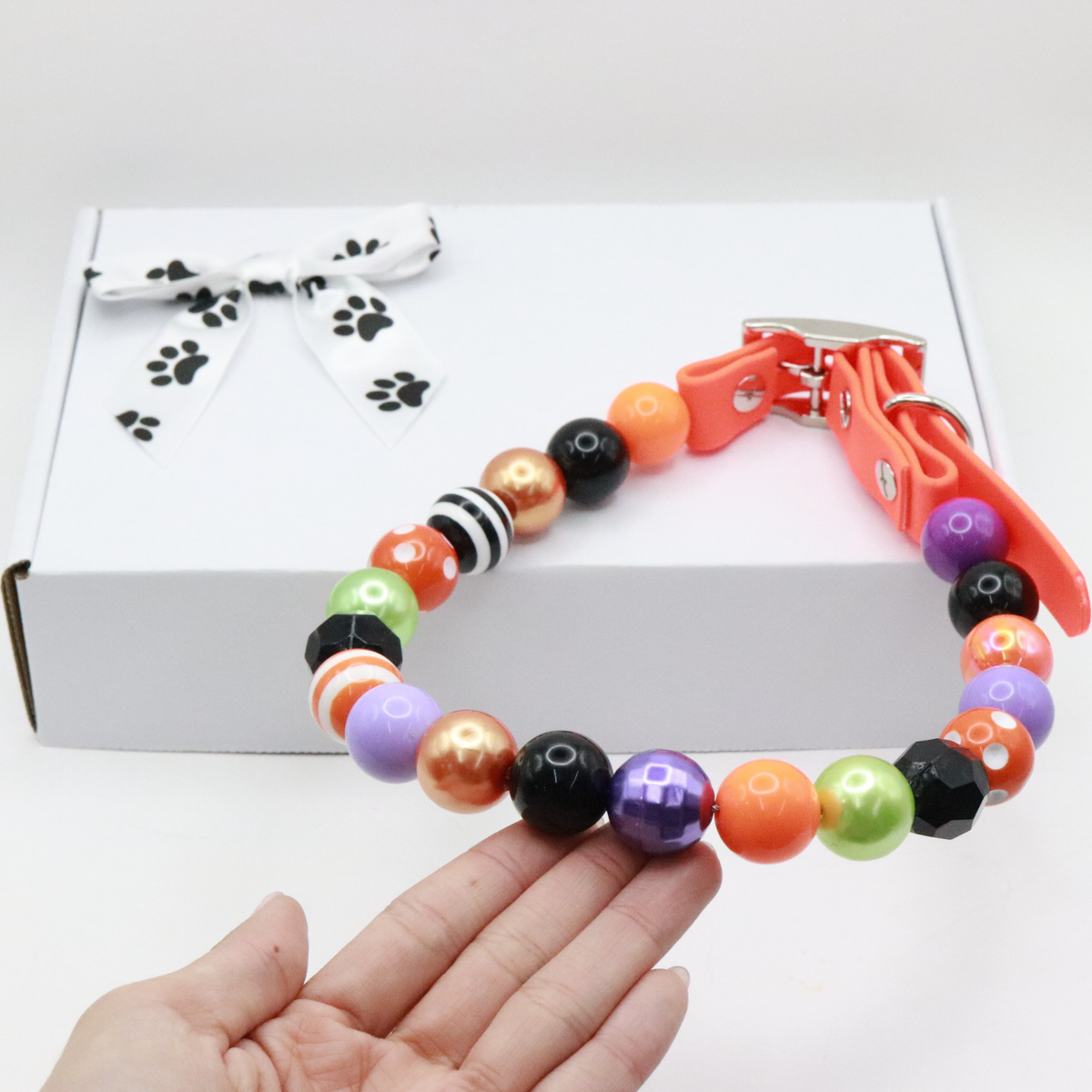 AnitasStitches adjustable Halloween dog collar with vibrant multi-colored beads and a durable orange Biothane strap.